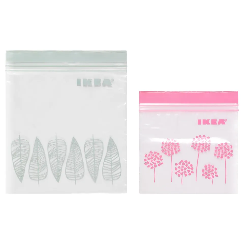 Two IKEA ISTAD resealable bags, one with green leaf designs, the other with pink floral patterns. Both are transparent with double seals.