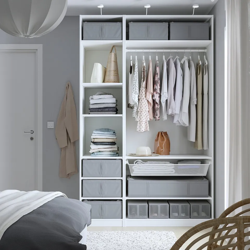Modern bedroom with a pax wardrobe, storing clothes, folded linens, and grey SKUBB storage cases, keeping items dust-free and organised.