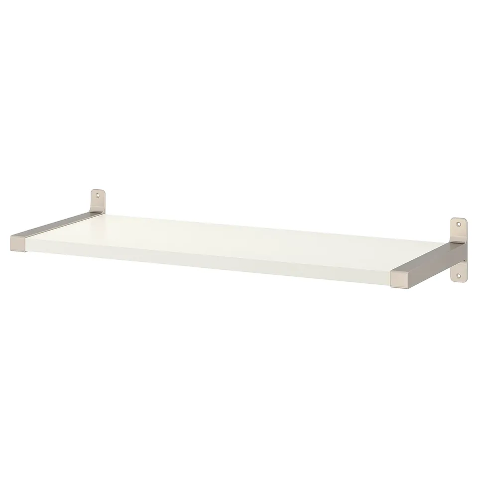 A white BERGSHULT wall shelf with a nickel-plated bracket. It one bevelled and one smooth edge, designed to be cut for custom sizing.