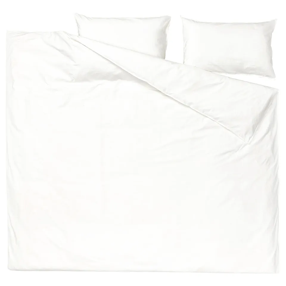 White bedding set, including duvet and pillows, made of soft, recycled cotton.