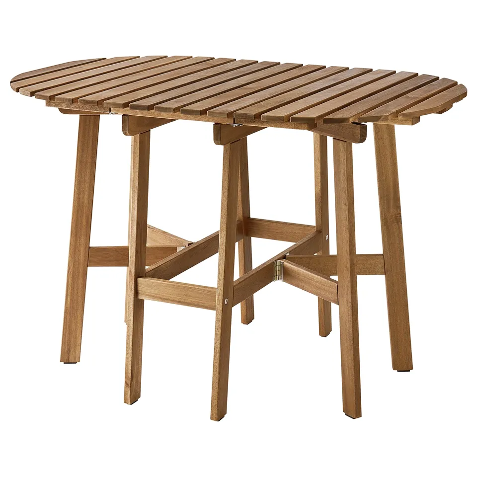An ASKHOLMEN outdoor table with a round wooden top and foldable legs in natural wood colour.
