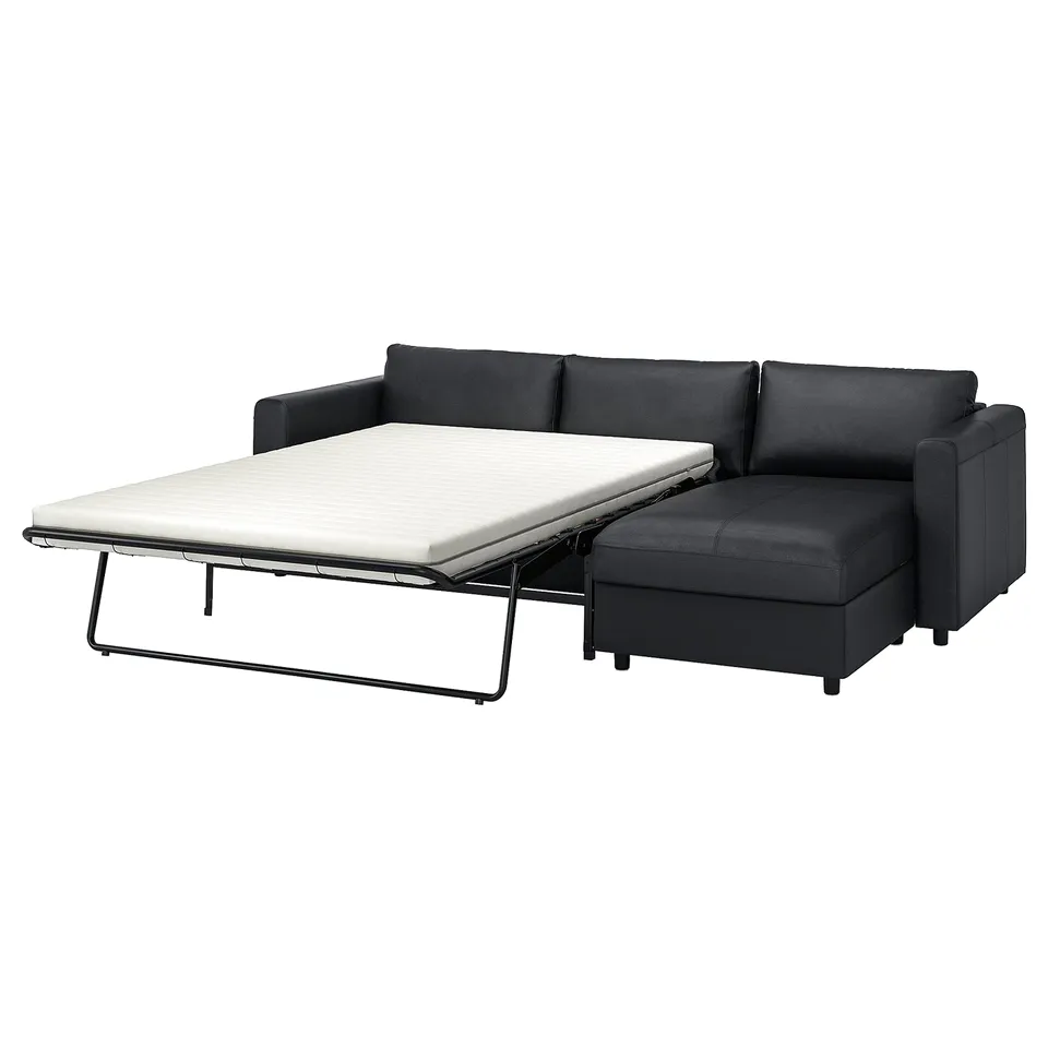 Dark grey VIMLE sofa-bed with chaise longue for seating and sleeping.