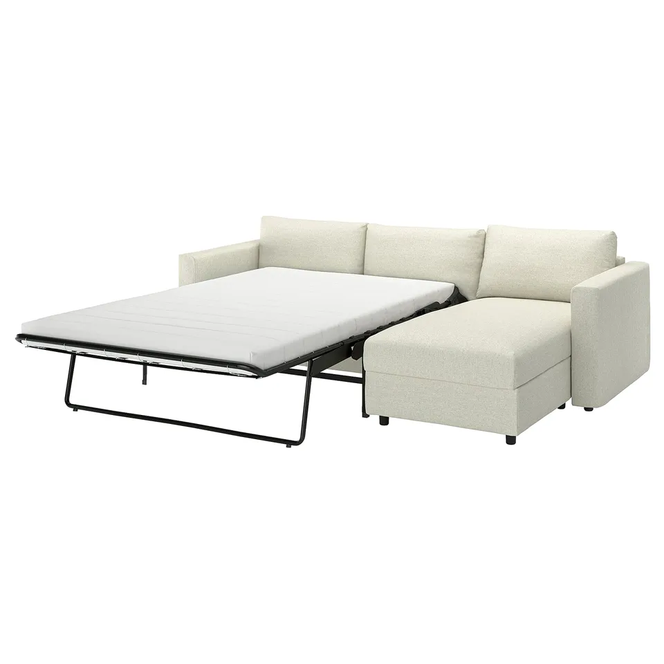 IKEA VIMLE sofa-bed in light beige, featuring a pull-out mattress on a metal frame, with a chaise lounge section and removable cushions.