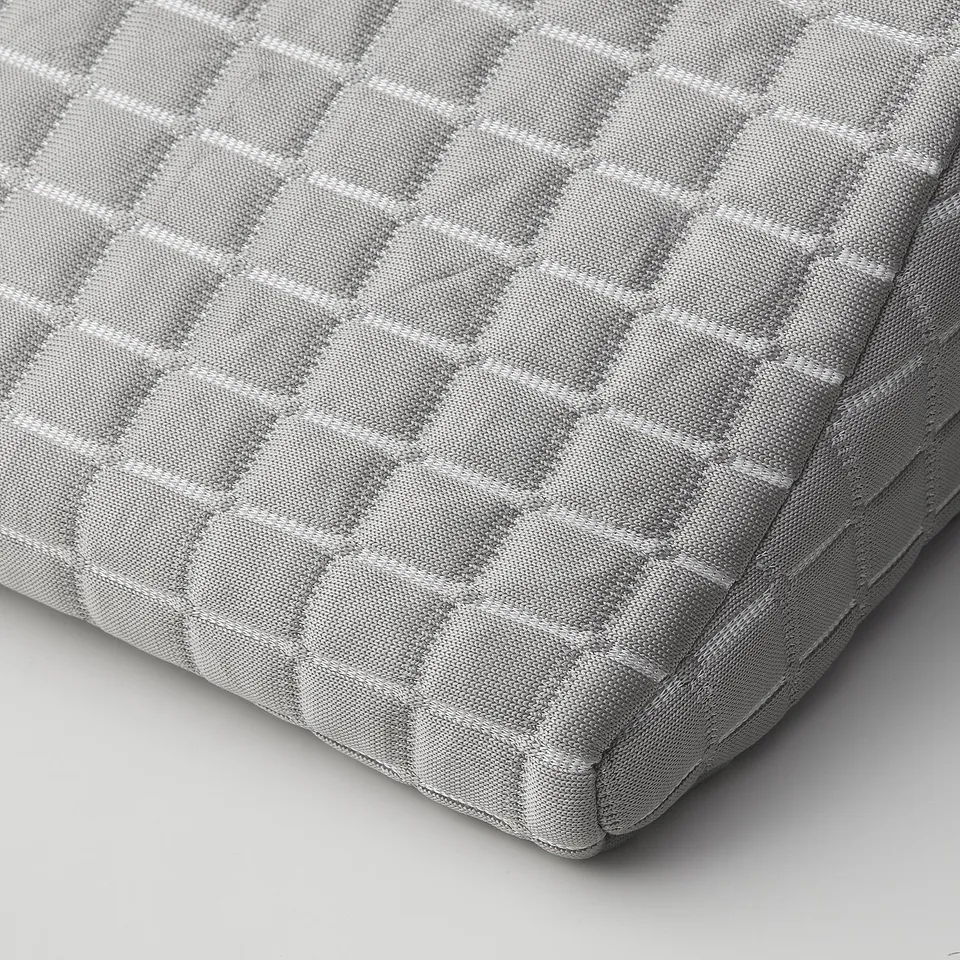 Close-up of BORTBERG lumbar cushion, showcasing its quilted, grey fabric and memory foam texture, emphasising comfort and quality.