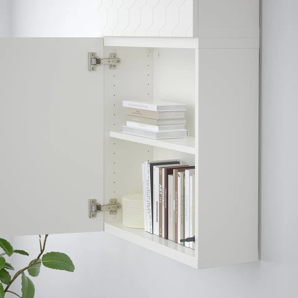 White bookshelf mounted on wall, featuring two shelves with books. Sturdy, adjustable design for versatile storage.