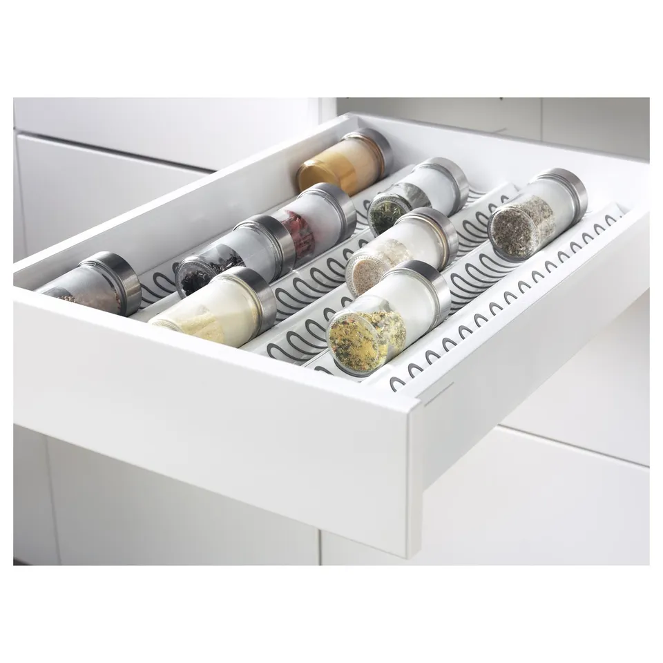 Kitchen drawer with spice jars.