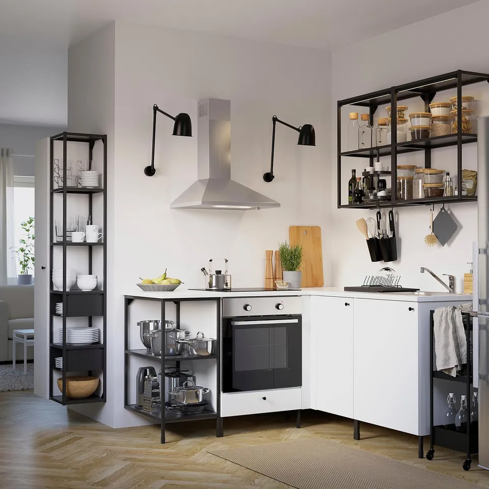 Modern kitchen with ENHET cabinets, metal shelves, stainless hood, and wood floors.
