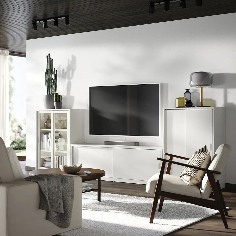 Modern living room with TONSTAD tv unit, wooden table, armchair, and grey rug; minimalist design.