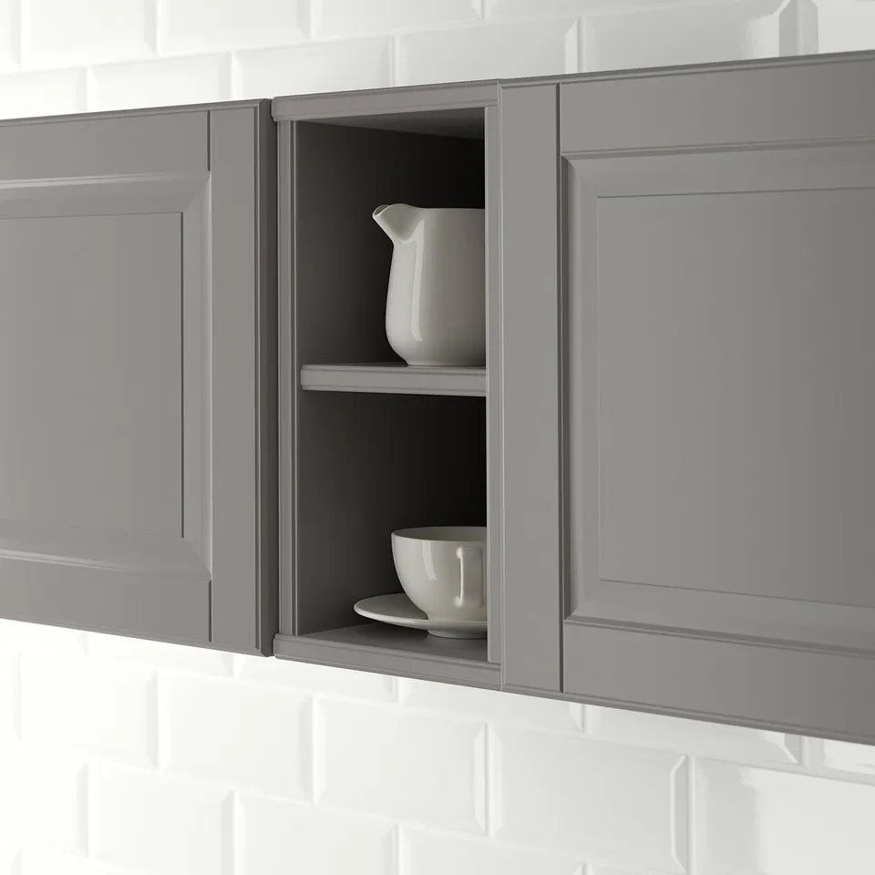 Open kitchen cabinet with two shelves displaying a jug and a bowl, part of the TORNVIKEN series.