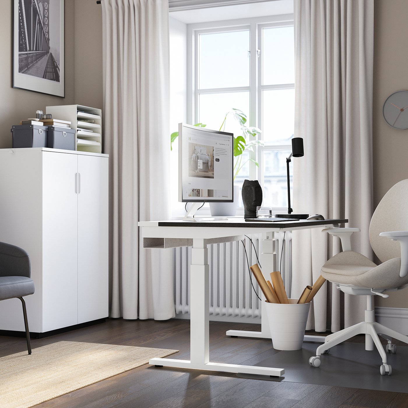 Modern home office: MITTZON white sit/stand desk by large window, chair, storage, plant, and art.