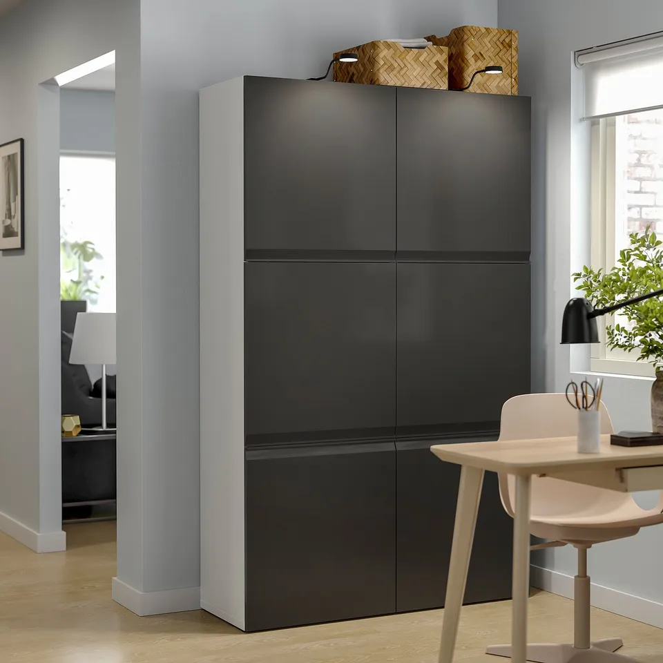 Black BESTÅ storage unit with two doors and shelves, modern design.