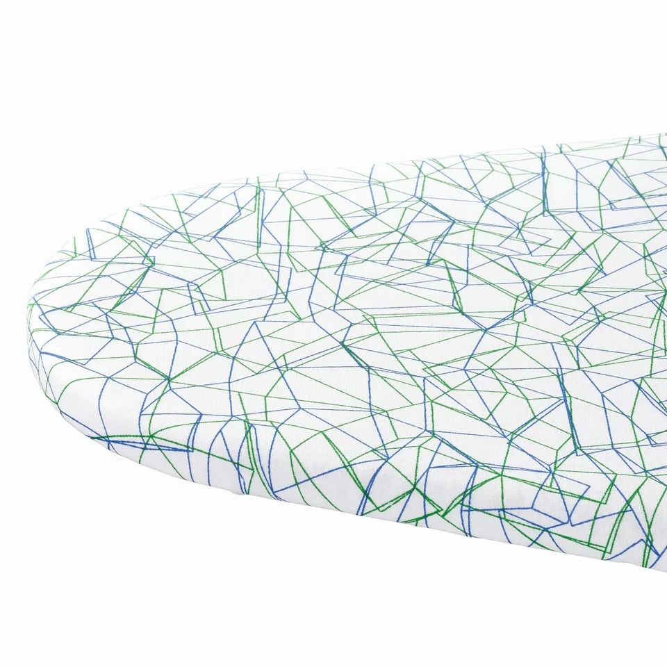 Abstract cushion with intricate blue and green thread patterns on white fabric.