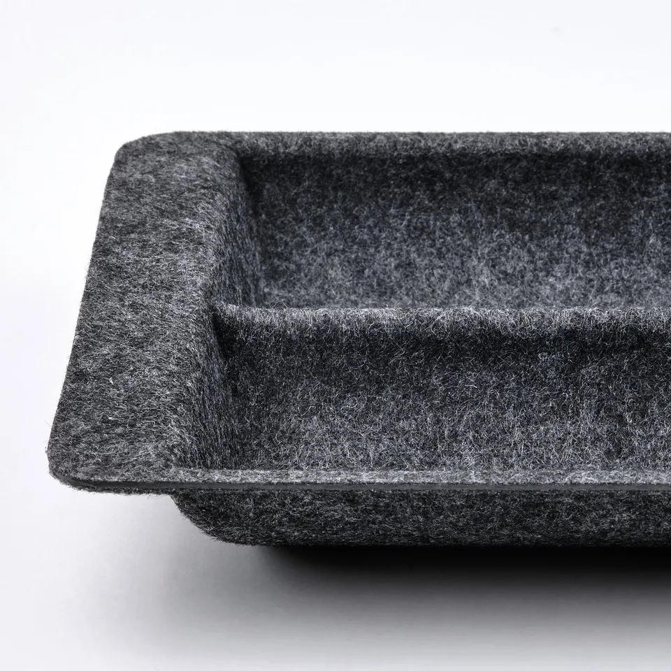 Black drawer organiser, textured, rectangular, smooth edges.