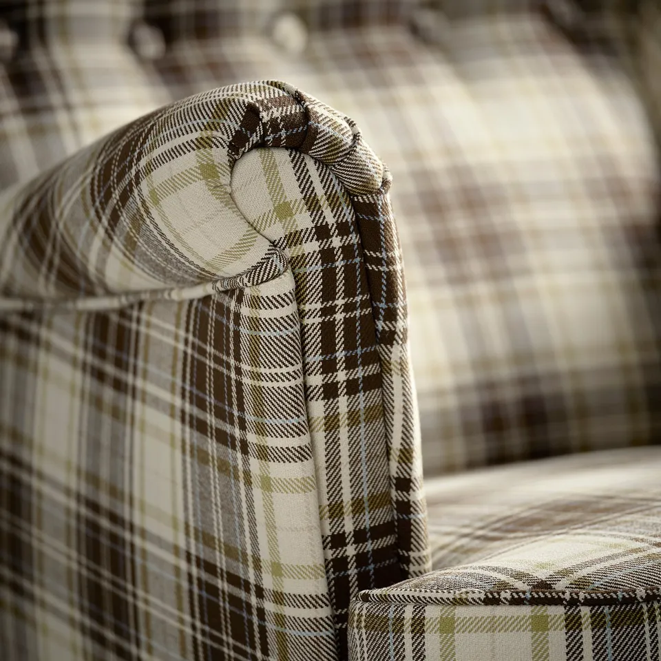 Close-up of high-quality checked fabric on a cosy, supportive chair back.