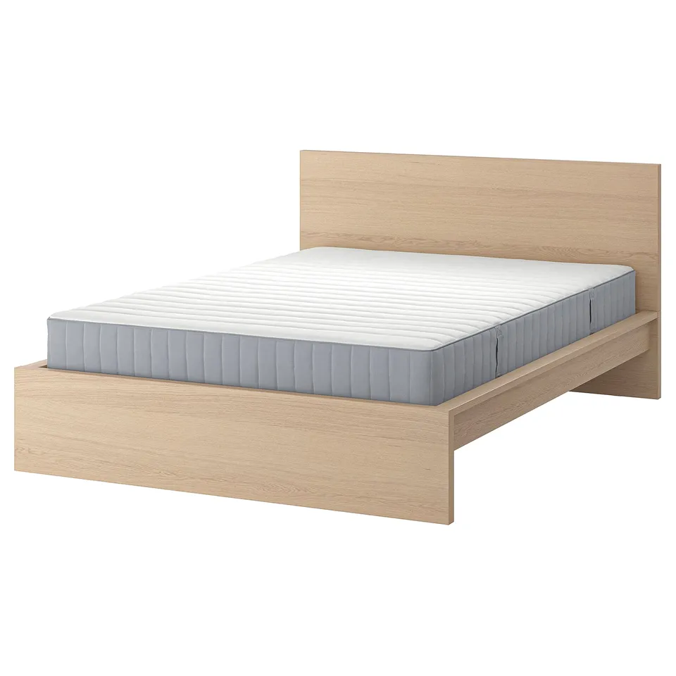 Modern light wood bed with grey mattress. Simple, clean design, no footboard.