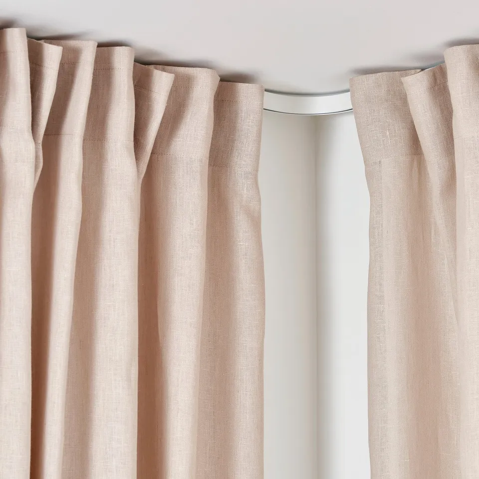 VIDGA rail system with beige curtains, showcasing easy assembly and flexibility.