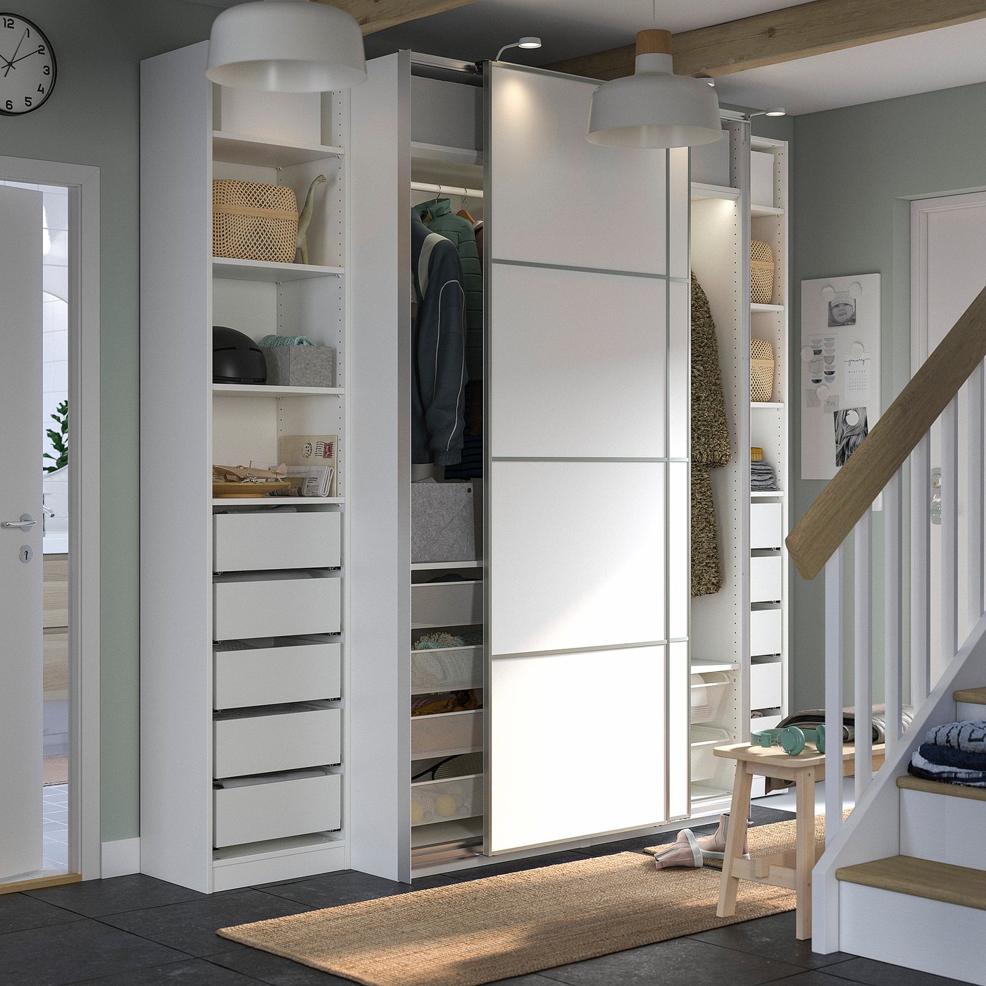 Modern white PAX wardrobe with drawers, shelves, and hanging space.