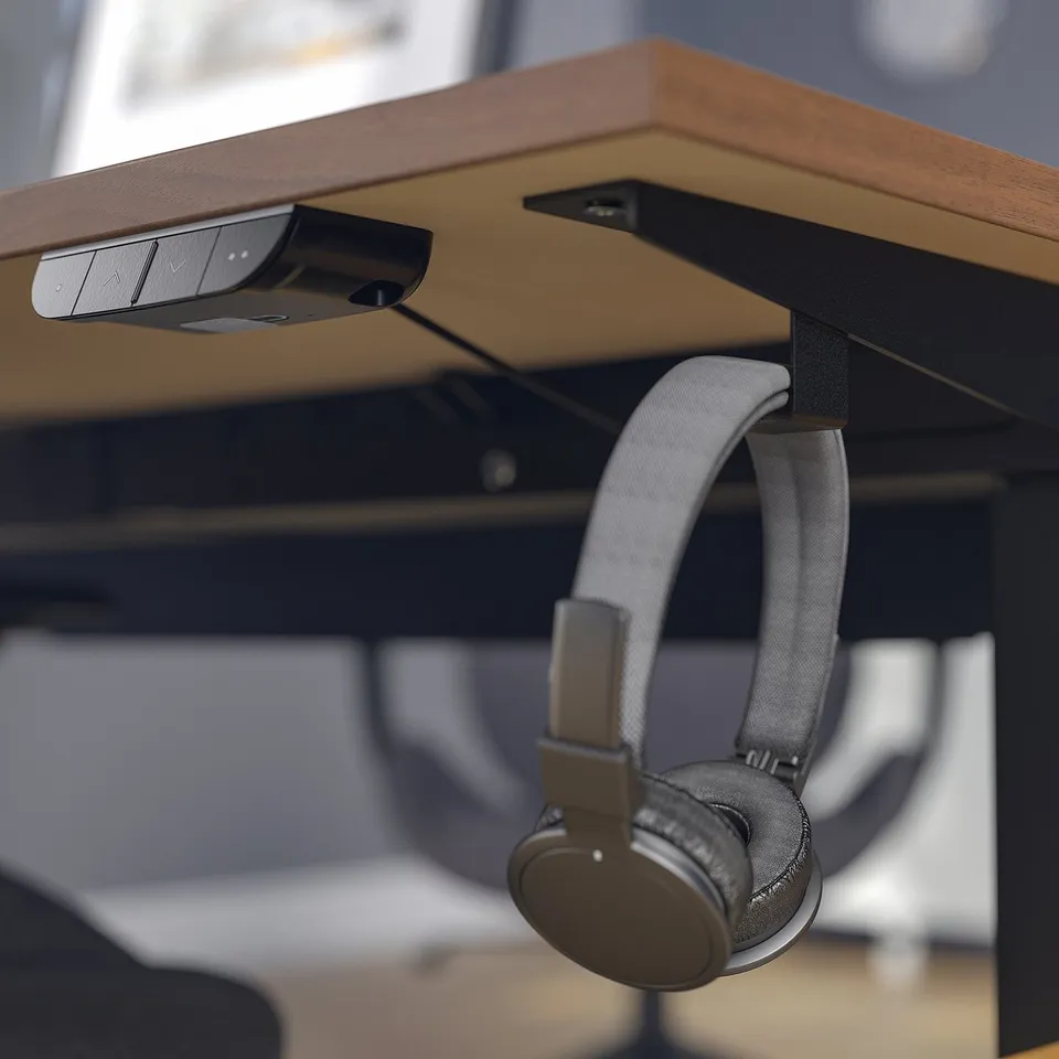 Desk with hooks holding headphones and control panel.
