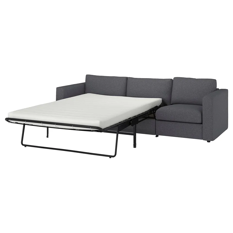 Grey fabric sofa-bed with thick mattress, convertible design.