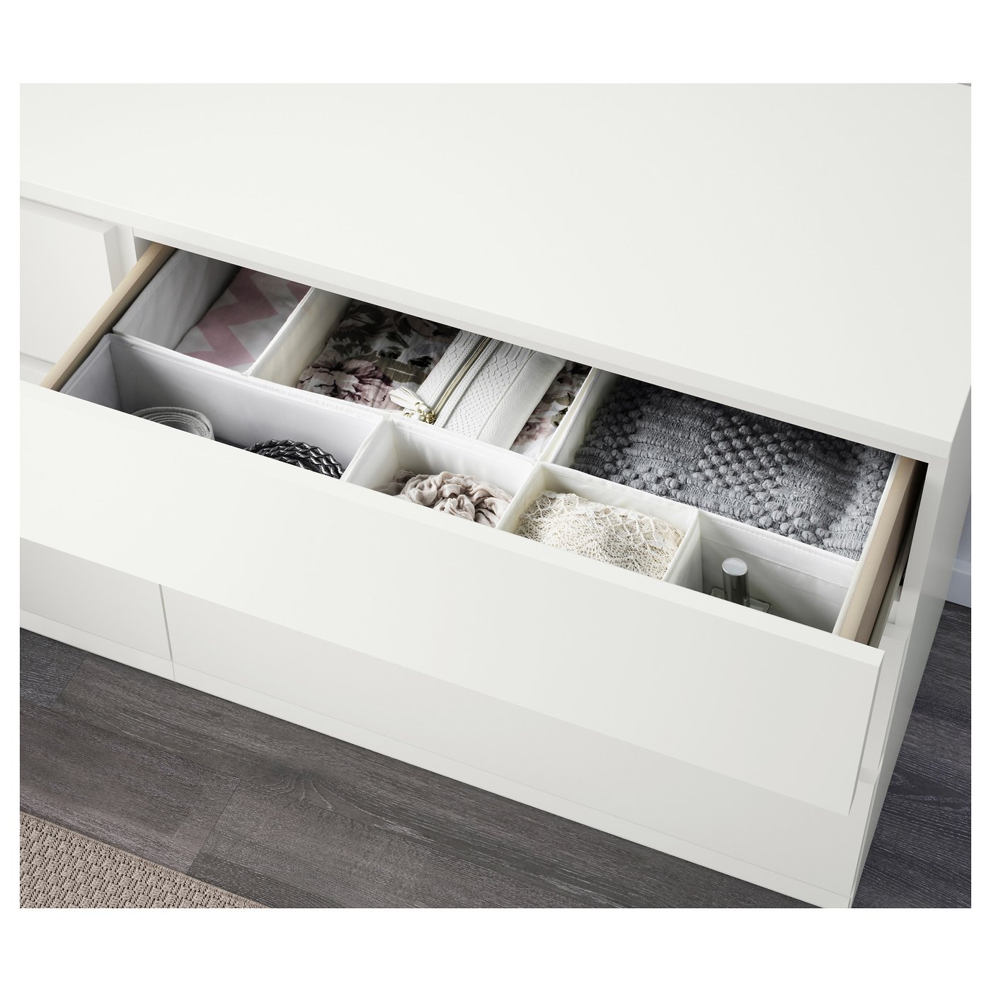 White dresser with drawer organisers for socks, underwear, and accessories.