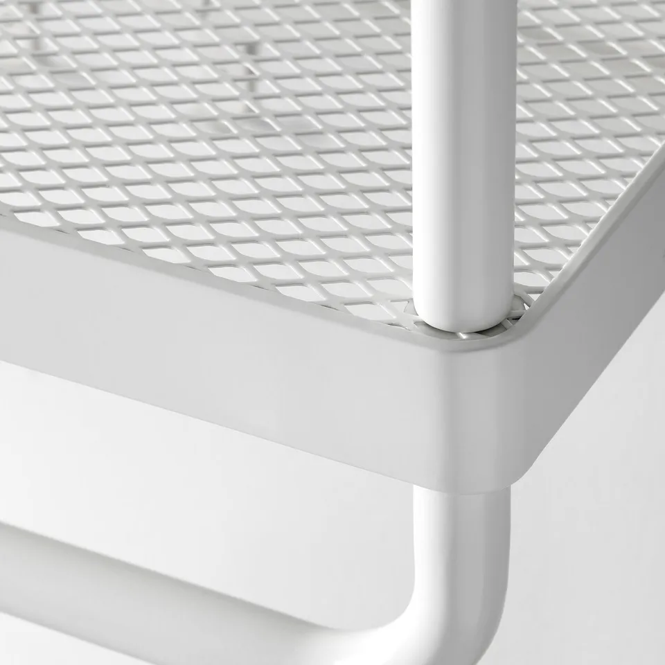 Close-up of white metal MACKAPÄR storage unit, showcasing durable mesh and strong design.