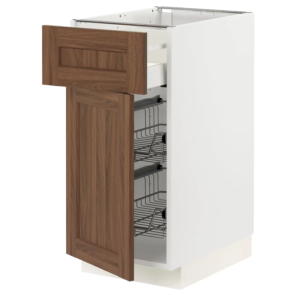 A white METOD kitchen cabinet with a walnut brown door and pull-out wire baskets for storage. It a modern, functional design.