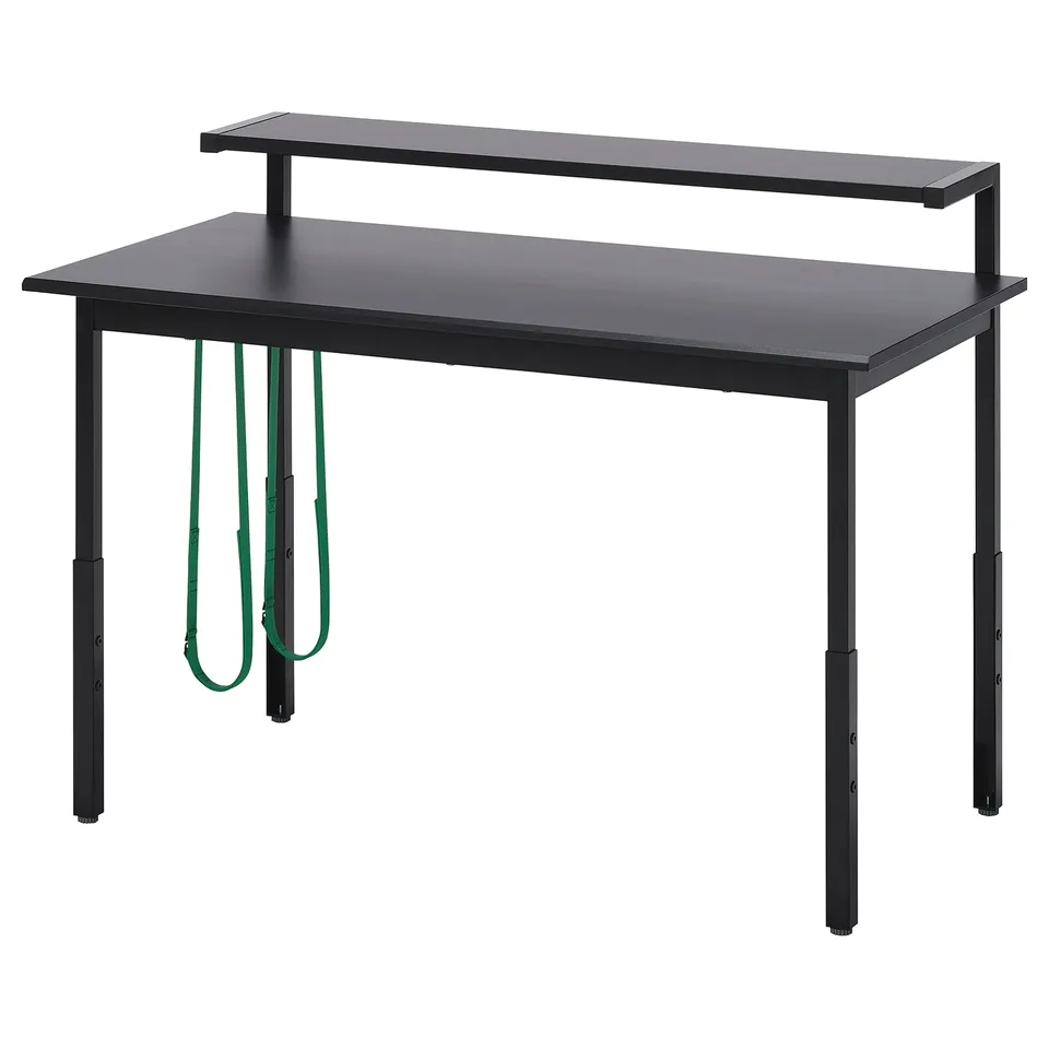 A black UTVISNING gaming desk with adjustable height, a monitor shelf, and cable management.