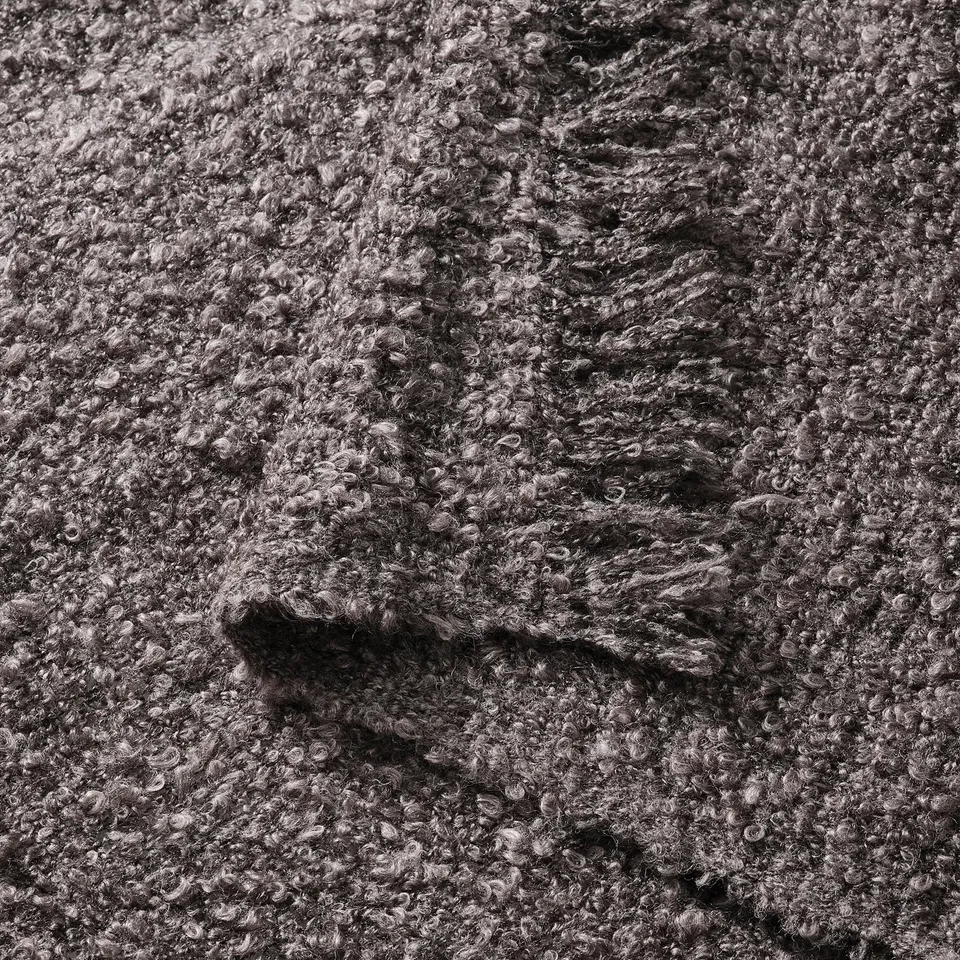 Textured grey throw blanket, soft, crinkle-knit weave, made from recycled polyester.