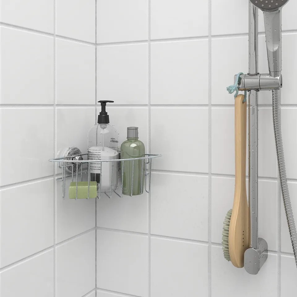 Shower caddy with suction cups holds shampoo, soap near showerhead.