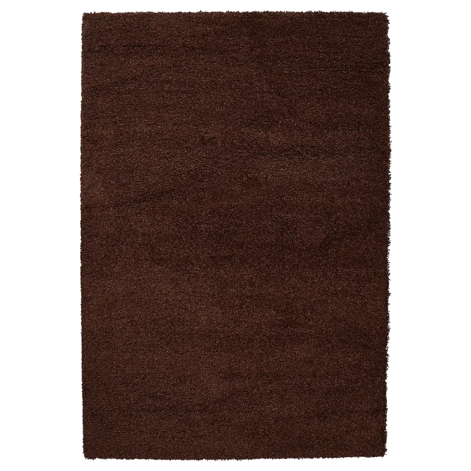 A square-shaped, dark brown area rug with a shaggy design, made from polypropylene and synthetic rubber.