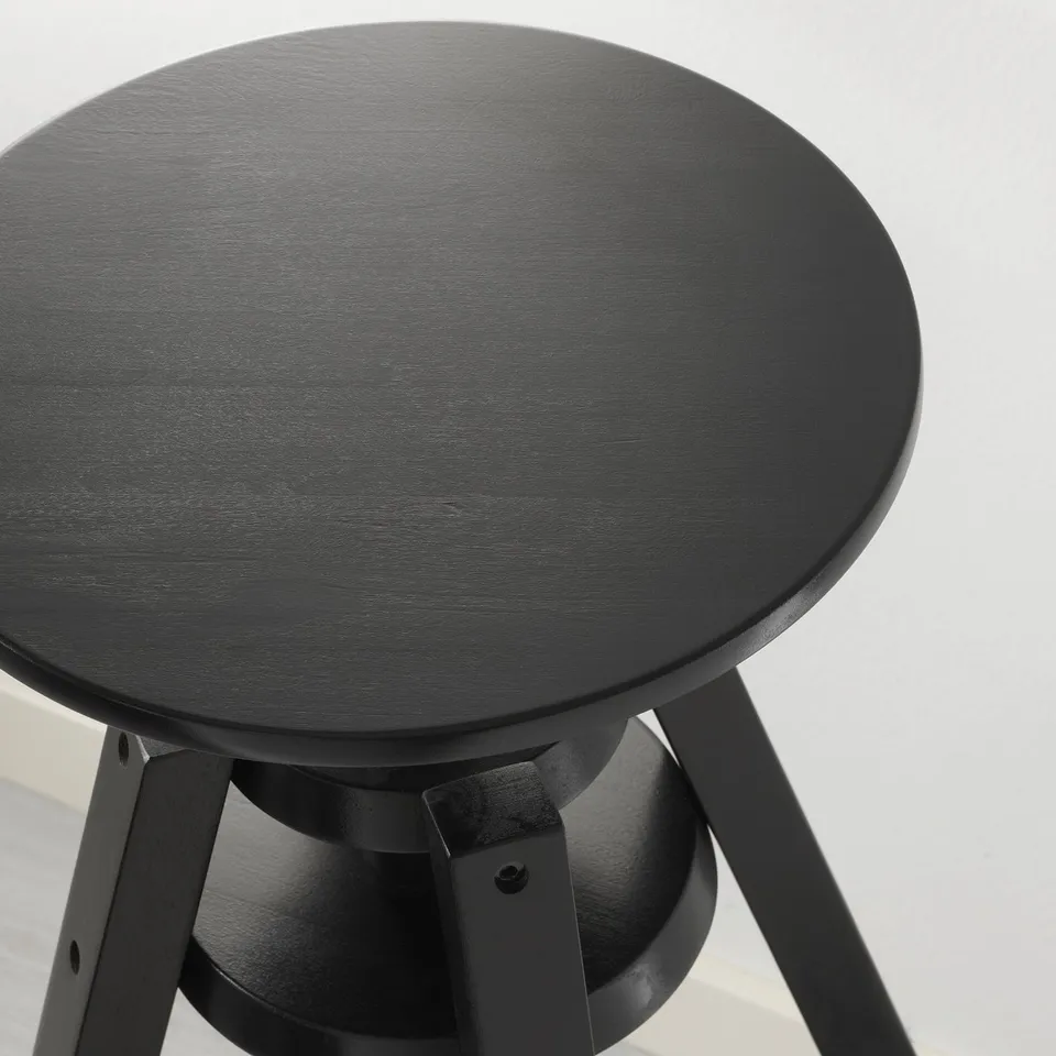 A modern, black height-adjustable stool with a round seat.