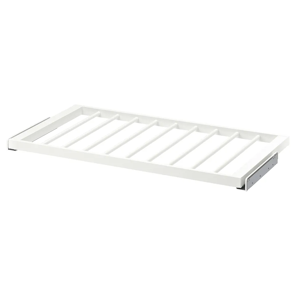 A white KOMPLEMENT trouser hanger shelf. It has a rectangular shape with slatted design, made of epoxy-coated steel.