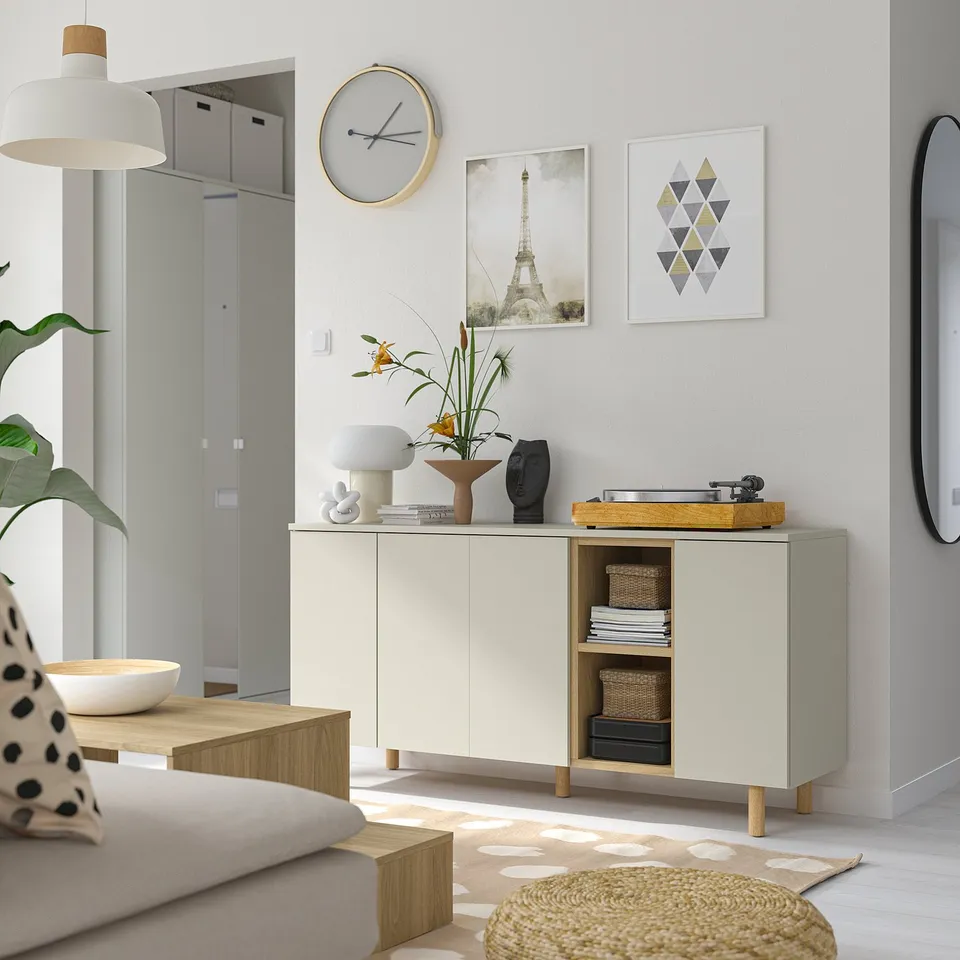 LEDAMOT cabinet, light wood, holds turntable, centrally placed with sofa and rug, grey wall contrast.