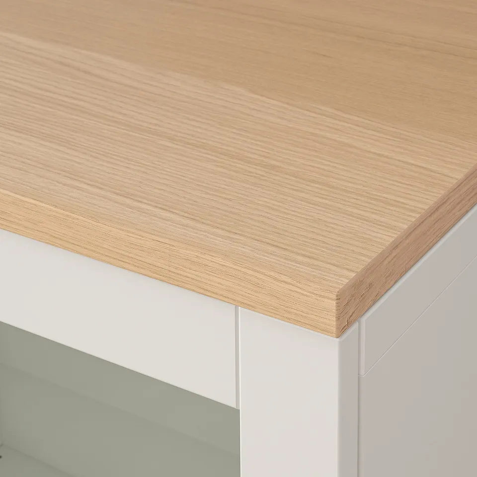 Close-up of BESTÅ units sleek, light wood top, highlighting smooth surface and sturdy build quality.