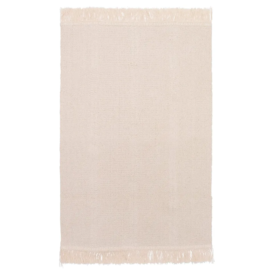 A beige, rectangular SORTSÖ cotton rug with fringed edges. Its flat-woven and looks the same on both sides.