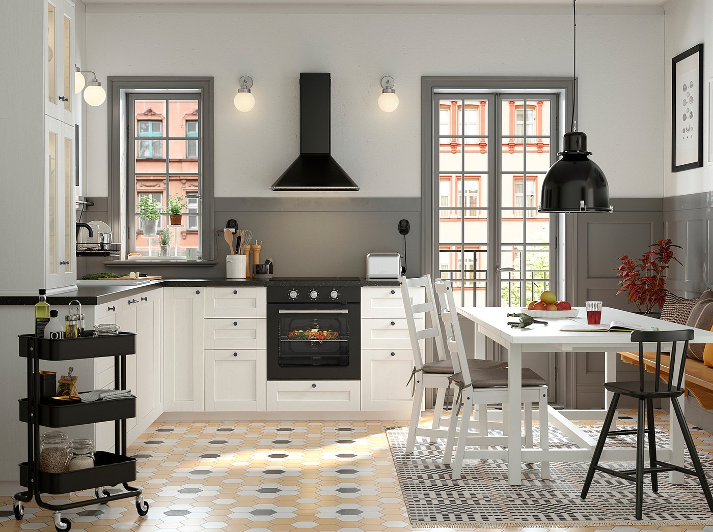 Modern kitchen with white ENKÖPING cabinets, black appliances, geometric floor tiles, and a dining area with a white table and black pendant light.
