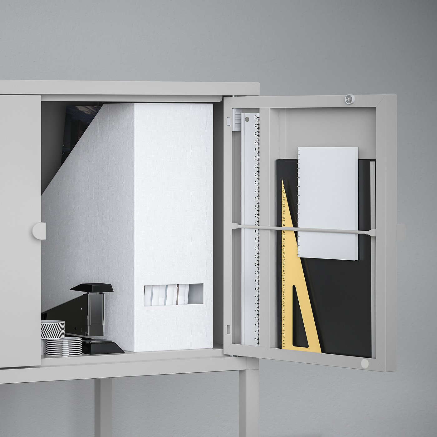 White cabinet with door open, showing inner storage compartments and a ruler.