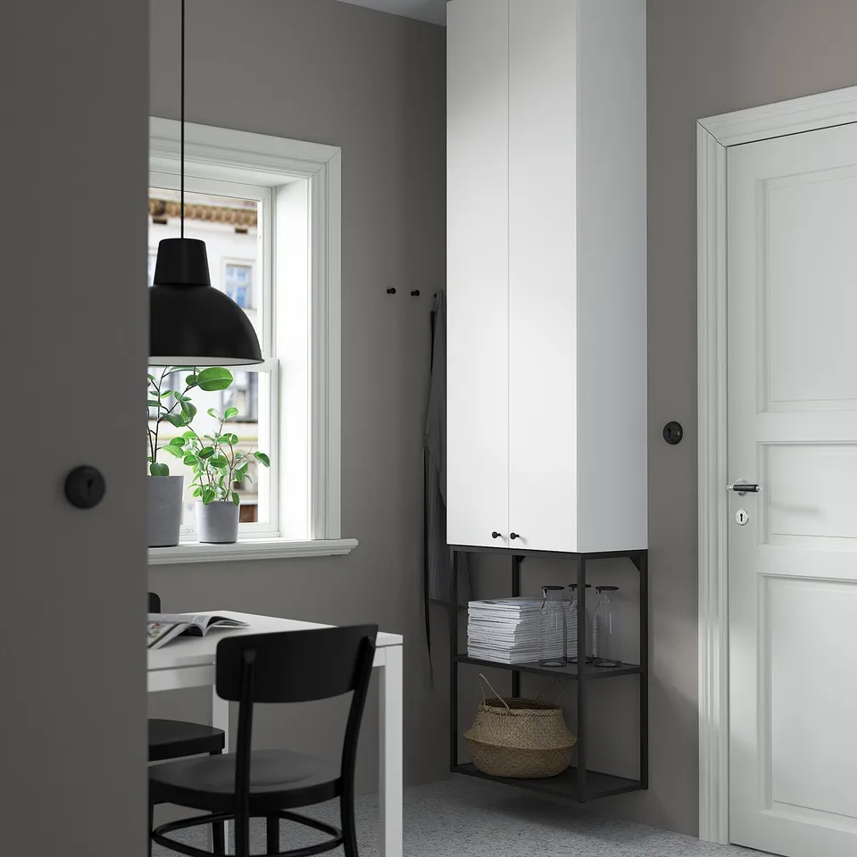 Modern ENHET storage in home office, white cabinet, black chair, desk, jars, basket, large window.