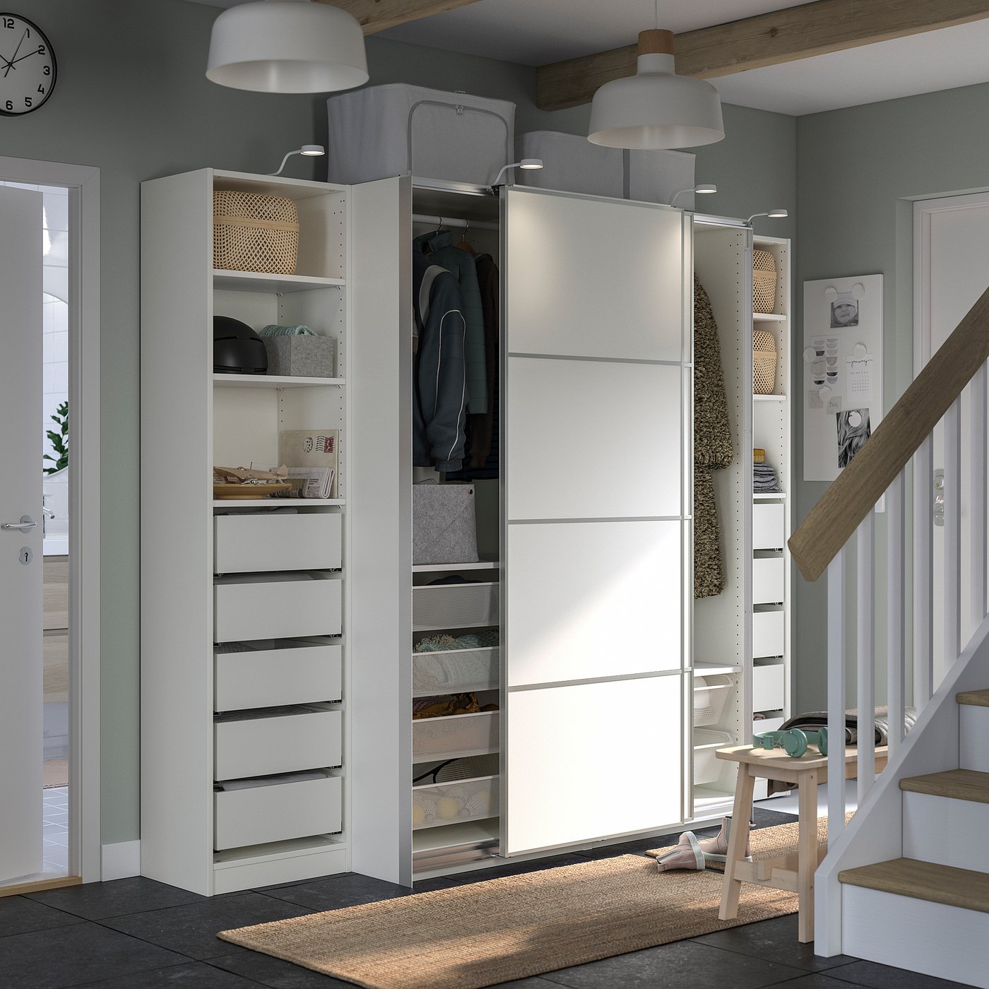 Modern white PAX wardrobe with drawers, shelves, and hanging space in a stylish room.