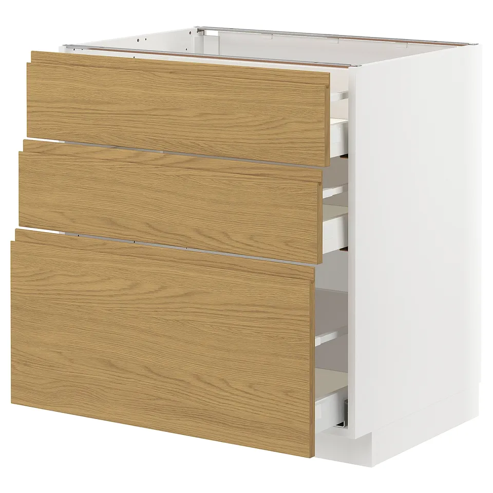 Modern kitchen cabinet with oak drawers. Three drawers, white base, sleek design.
