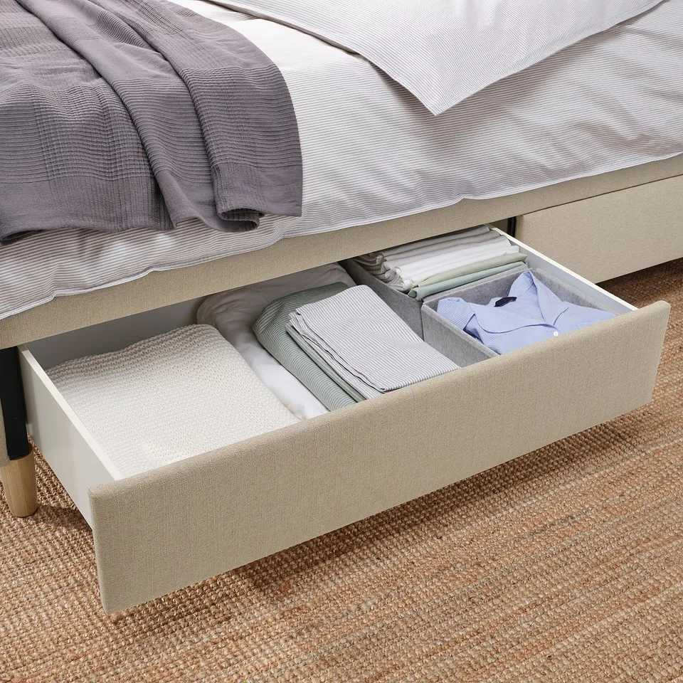 An upholstered bed with soft-closing drawers, offering under-bed storage.