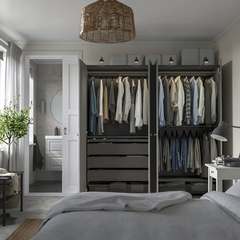 Bedroom wardrobe with clothes, drawers, and storage.