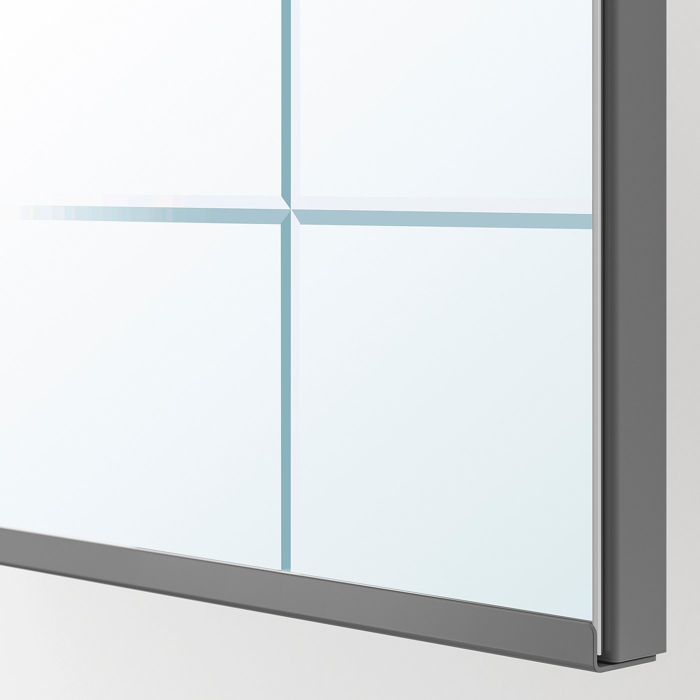 Close-up of a modern mirror edge with refined milled pattern, clear glass reflection.
