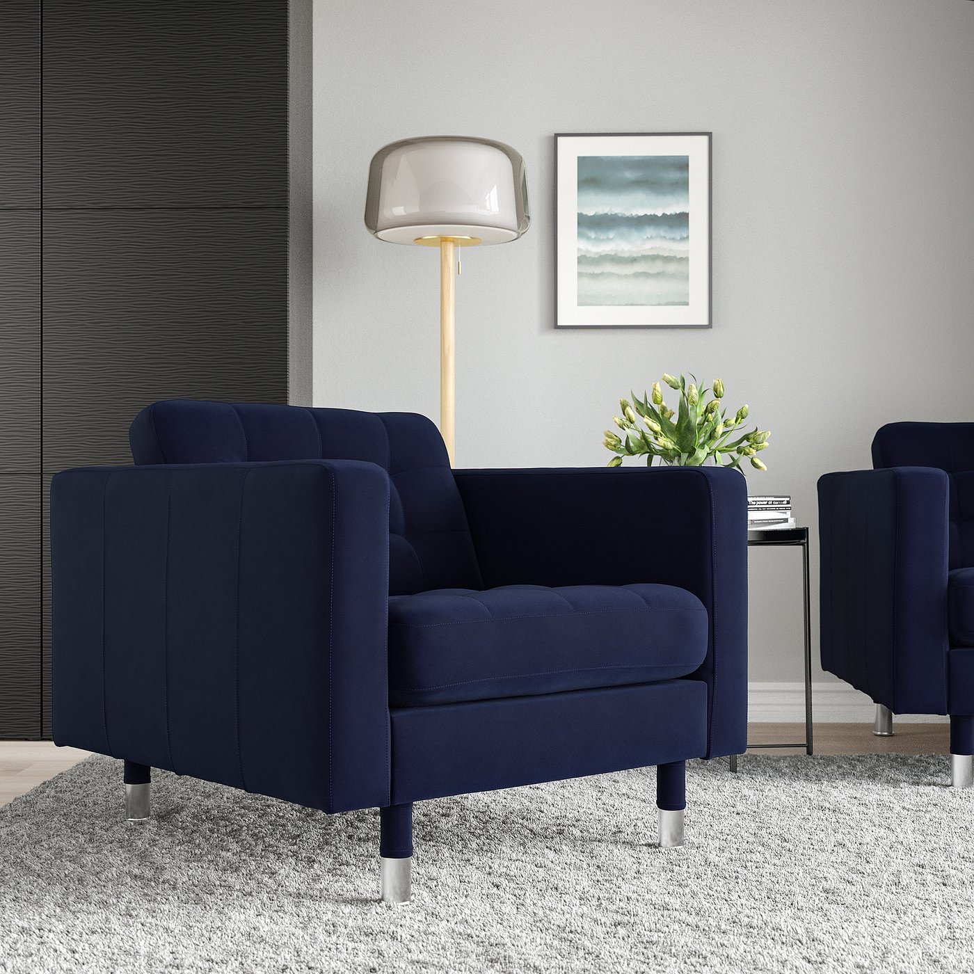 Navy LANDSKRONA armchair with cushions in modern room, next to lamp and abstract art, perfect for small spaces.