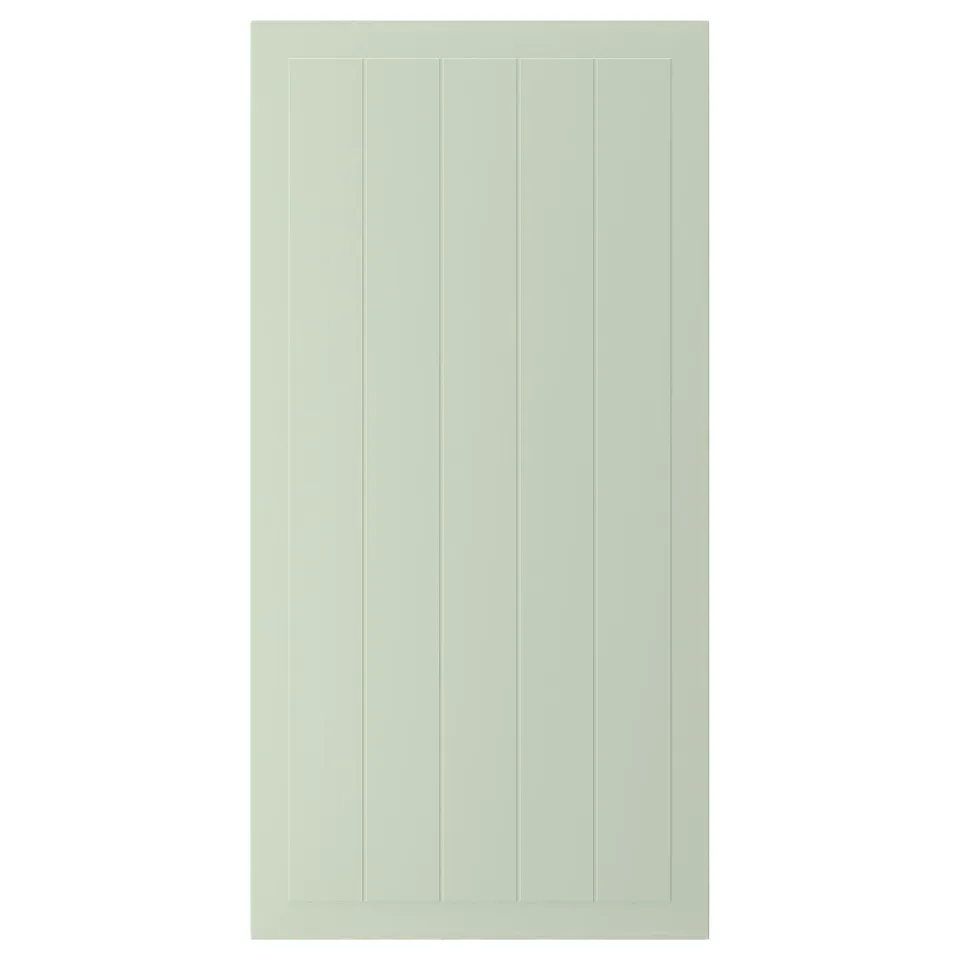 A green STENSUND cabinet door with vertical grooves, made from fiberboard and painted with polyurethane and acrylic finishes.