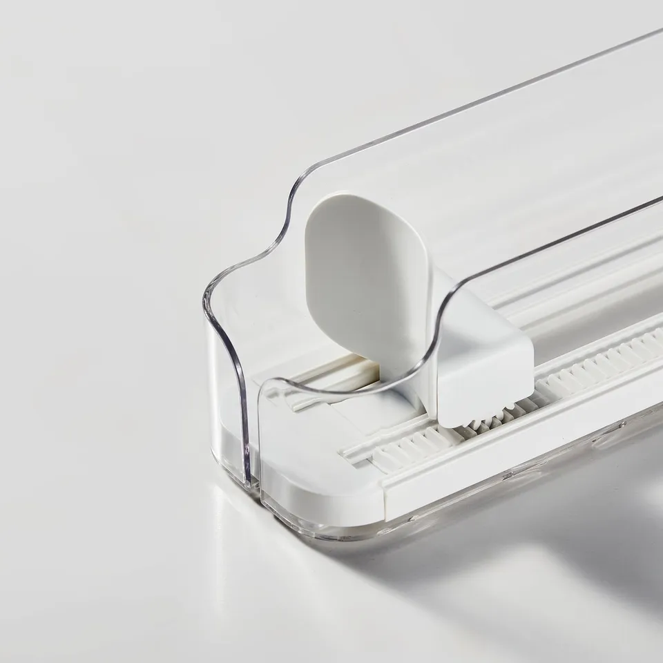 Clear drink holder with adjustable sides, white lever, and gear, designed for organising cans/bottles.