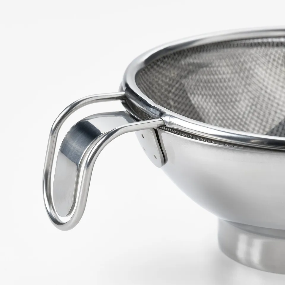 Close-up of a stainless steel strainer handle, showcasing its sleek, durable design.