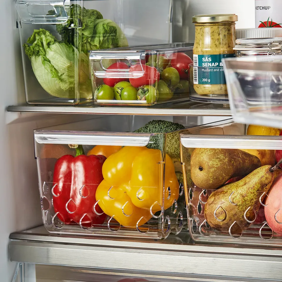 Fridge organisation: clear storage bins with ventilation, easy access handles, for fresh veggies and fruits.