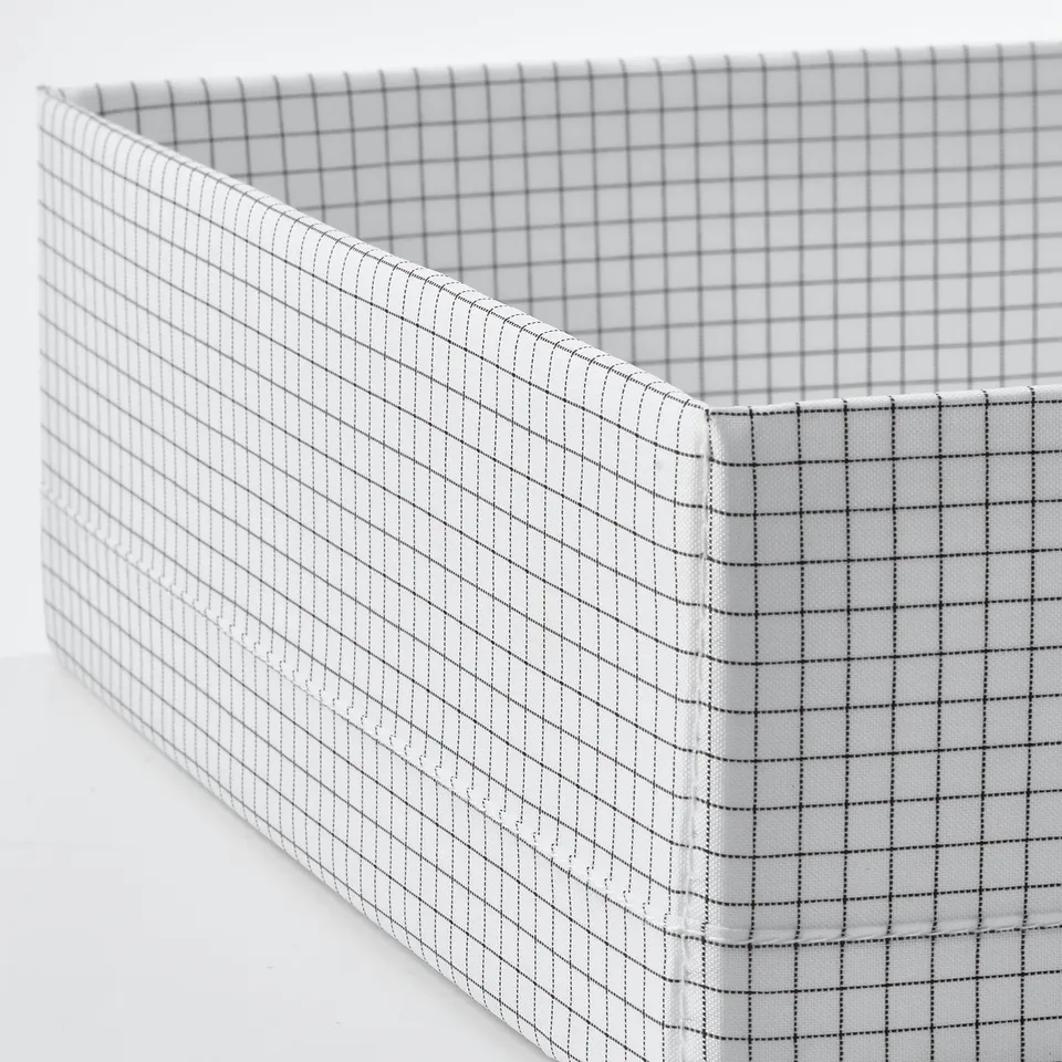 White fabric storage box with grid pattern, sturdy build, divided compartments, neatly stitched.