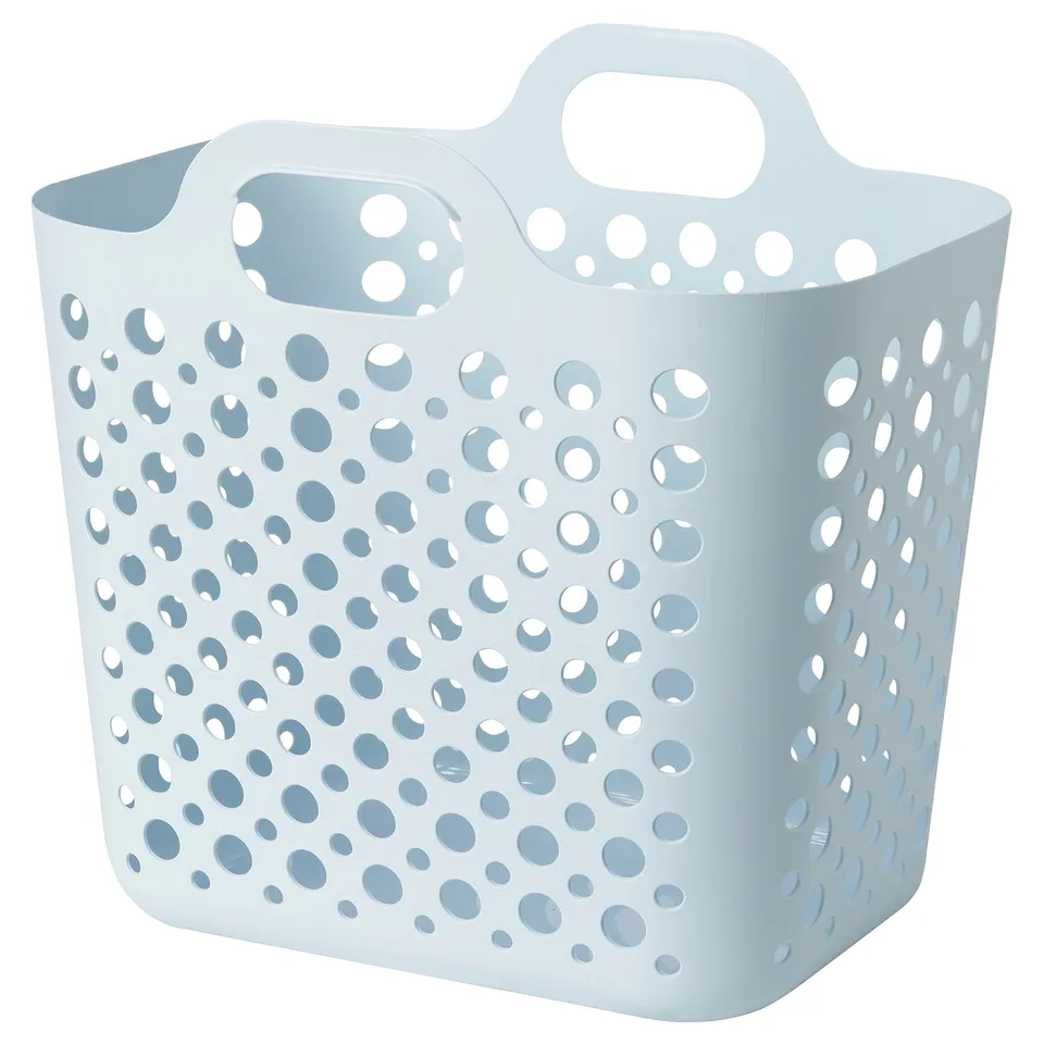 A blue, perforated plastic laundry basket named SLIBB, with handles for easy carrying, designed for storing and transporting clothes.